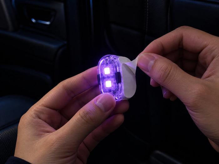 Peeling the backing film off the adhesive pad of a light pod